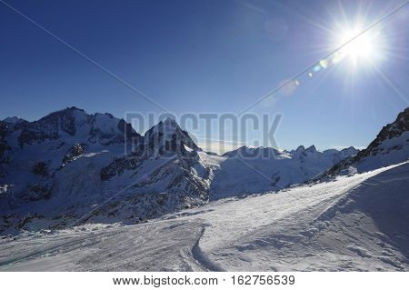 amazing scenic view of snow mountains and ski in Switzerland Europe on a cold sunny day with blue sky at Saint Moritz Corvatsch peak in Engadin in winter vacation and holiday concept
