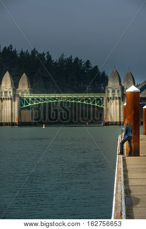 Tourist Looking At Siuslaw River Bridge From The Florence Marina Oregon
