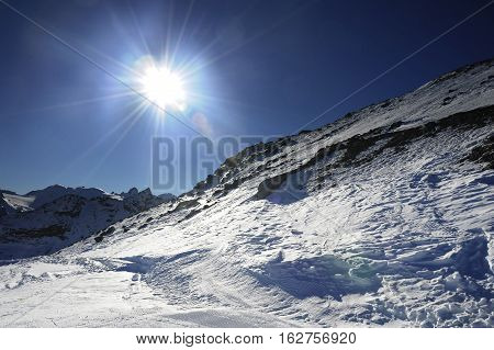 amazing scenic view of snow mountains and ski in Switzerland Europe on a cold sunny day with blue sky at Saint Moritz Corvatsch peak in Engadin in winter vacation and holiday concept