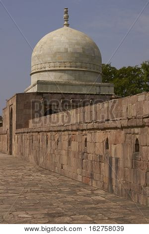 MANDU, MADHYA PRADESH, INDIA - NOVEMBER 18, 2008: Ancient islamic tomb of Hoshang Shah in the hilltop fortress of Mandu in Madya Pradesh, India. White marble building. 15th Century AD