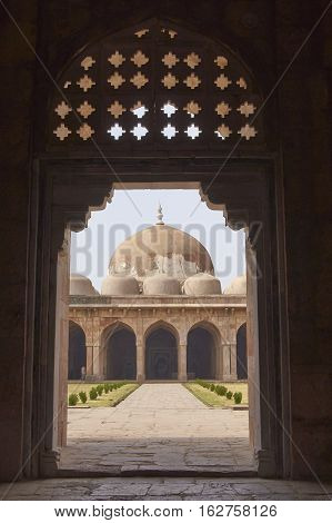 MANDU, MADHYA PRADESH, INDIA - NOVEMBER 18, 2008: Inner courtyard and covered prayer hall of the ancient mosque of Ashrafi Mahal Mosque in the hilltop fortress of Mandu in Madya Pradesh, India. 15th Century AD