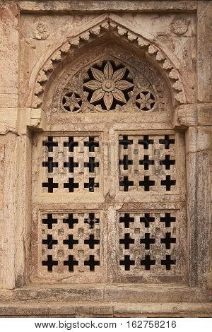 MANDU, MADHYA PRADESH, INDIA - NOVEMBER 18, 2008: Detail of stone window of Darya Khan's tomb in the hilltop fortress of Mandu. 16th Century AD