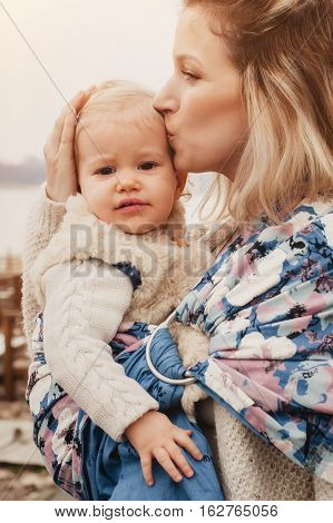 Young Mother Having Her Little Daughter In Baby Carrier Scarf