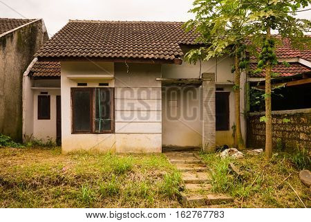 abandon house not maintained with bush and small plant grow near that in bogor indonesia java