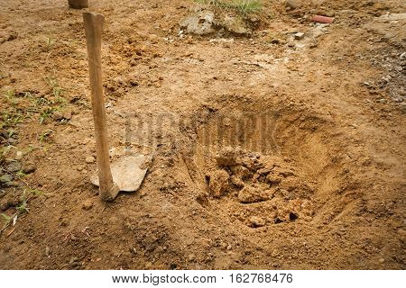 Preparing a hole with a dirty hoe photo taken in Bogor Indonesia java
