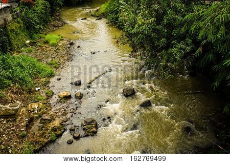 A dirty river flow photo taken in Bogor Indonesia java