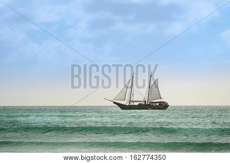 Sailboat Navigating As A Background In Aruba