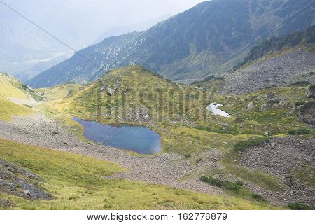 Beautiful Mountain Lake Surrounded By Impressive Mountains Of The Khamar-daban.