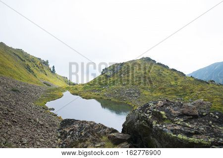 Beautiful Mountain Lake Surrounded By Impressive Mountains Of The Khamar-daban.