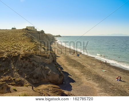Tourists Enjoying Vlichada Beach On The Island Of Santorini