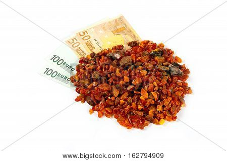 unwrought precious mineral amber and cash Euro banknotes as payment