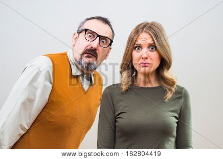 Nerdy man is trying to get beautiful woman's attention but she is not interested and desperately thinking the way to escape.