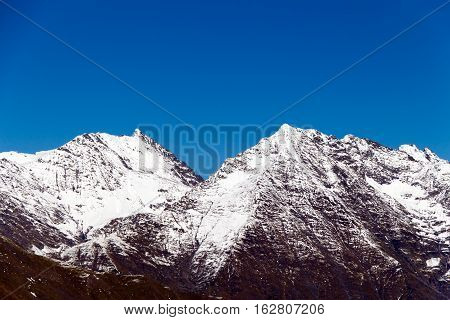 The Tops Of The Mountains Covered With Snow.