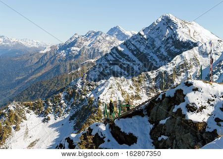 The Tops Of The Mountains Covered With Snow. A Man And A Woman Coming The Stairs. The Slopes Are Thi