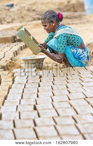 Illustrative image. Pondicherry Tamil Nadu India - July 03 2014. Poor woman worker in small village very hard work for little money roupies