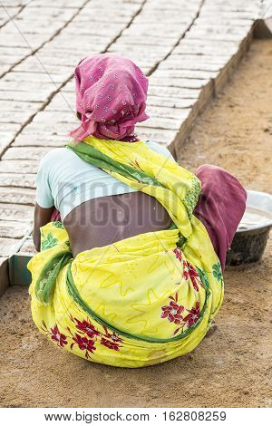 Illustrative image. Pondicherry Tamil Nadu India - July 03 2014. Poor woman worker in small village very hard work for little money roupies