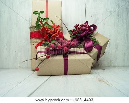 Gifts box with red bow on wood background