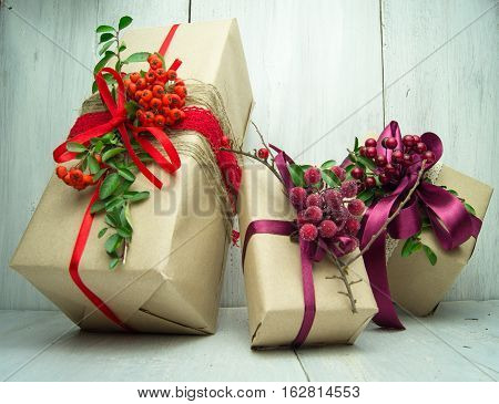 Gifts box with red bow on wood background