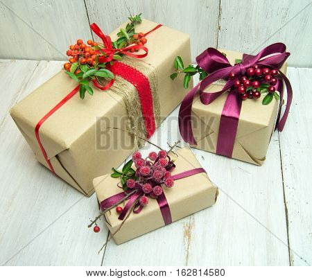 Gifts box with red bow on wood background