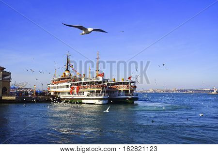 Istanbul Turkey - February 2 2014: Passenger steamers on Kadikoy scaffolding. The opposite shore looks to the European side of Istanbul the Blue Mosque and Hagia Sophia. Istanbul Ferries (called vapur in Turkish) continue to serve as a key public transpor