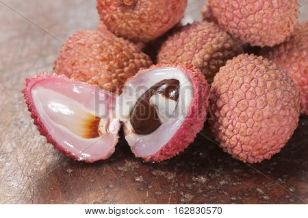 Lychee berries on a timber board close up