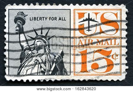 UNITED STATES OF AMERICA - CIRCA 1961: A used US air mail postage stamp depicting an illustration of the iconic Statue of Liberty circa 1961.