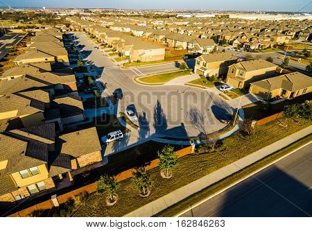 Sunset Suburban Homes North of Austin near Round Rock , Texas as Texas expands more and more homes are built in Modern Neighborhood Communities at Cul de Sac golden hour sunset