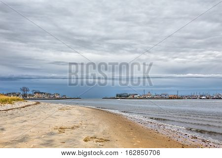 Manasquan Inlet at the New Jersey Shore separating the towns of Manasquan and Point Pleasant. It is a cloudy day.