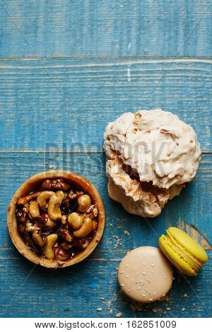 Sweet pecan cupcake, macaron and meringue on wooden table