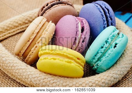 Set of sweets from cookies macaron on table cloths made of textile