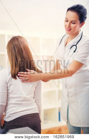 Chiropractor doing adjustment on female patient at office