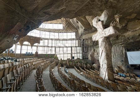 Cairo, Egypt - December 18 2016: View of St. Samaan the Tanner Hall showing a big cross at a huge cave, Saint Samaan The Tanner Monastery