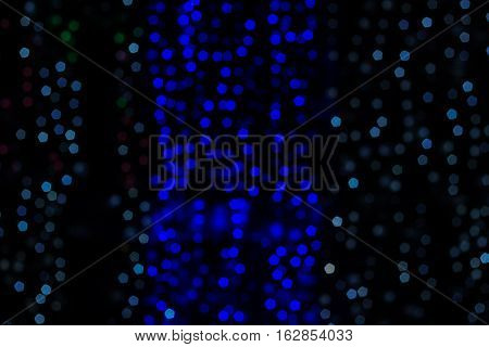 Abstract night background blur of blue and white points of light