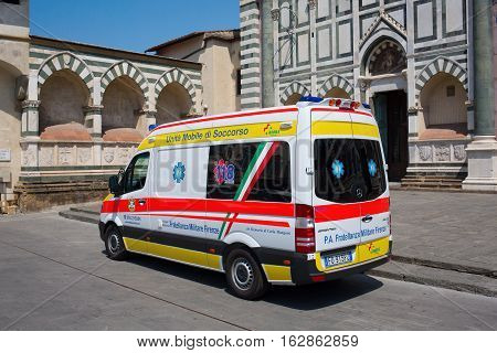 Florence Italy - July 06 2016: ambulance van in front of a historic church in Florence. In medieval time Florence was the center of European trade and one of the wealthiest cities