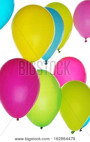 Colorful balloons in bunch on light background; vertical orientation