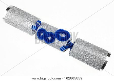 A shot of a 80th Birthday Cracker or otherwise known as a Bon Bon. A traditional cracker consists of a cardboard tube wrapped in a brightly decorated twist of paper with a gift in the central chamber.