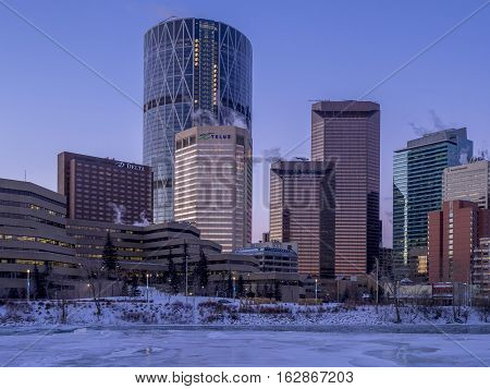 CALGARY, CANADA - DEC 17: Calgary's skyline at sunrise on a cold winter day on December 17, 2016 in Calgary, Alberta. Calgary is home to many oil companies. The Bow River is visible.