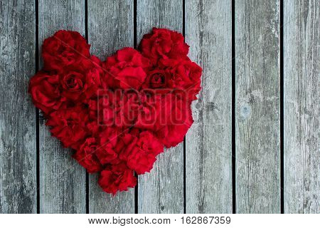 Heart of red roses on the boardwalk. Red rose.