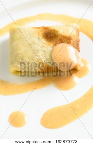 Hungarian Hortobagyi Palacsinta or Crepe a la Hortobagy a savory thin pancake filled with minced meat and served with a paprika and sour cream sauce based on the sauce of the meat photographed with natural light (Selective Focus Focus on the front of the