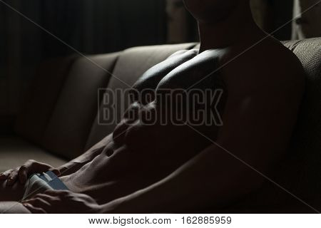 Muscular Shirtless Young Man Laying In Bed