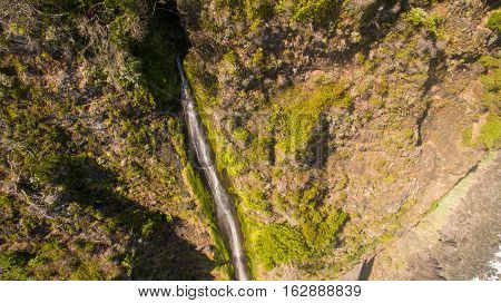 View of cliff edge and waterfall in Madeira island