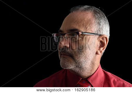 Portrait of a middle aged man on black