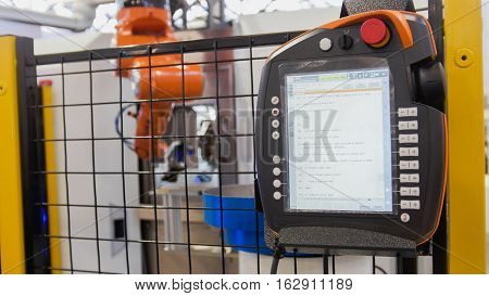 LCD remote control for robotic hand machine tool at industrial manufacture factory, close up