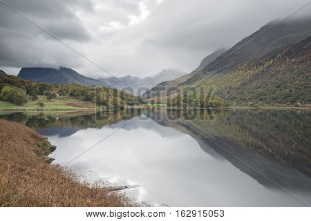 Beautiful Autumn Fall Landscape Image Of Crummock Water At Sunrise In Lake District England