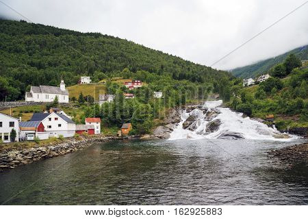 HELLESYLT, NORWAY - JULY 6, 2016: Hellesyltfossen is one of many Norwegian waterfalls in the area Geirangerfjord in village Hellesylt.