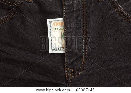 hundred dollar bill inside codpiece black jeans closeup