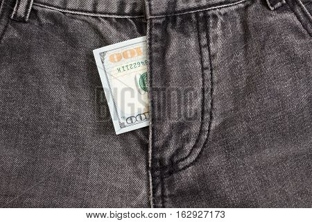 hundred dollar bill inside codpiece gray jeans closeup