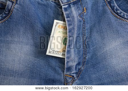 hundred dollar bill inside codpiece blue jeans closeup