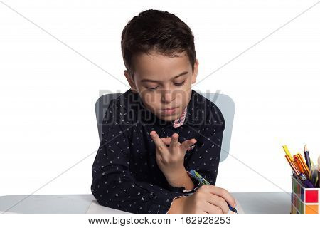 Student doing math calculation at his desk.