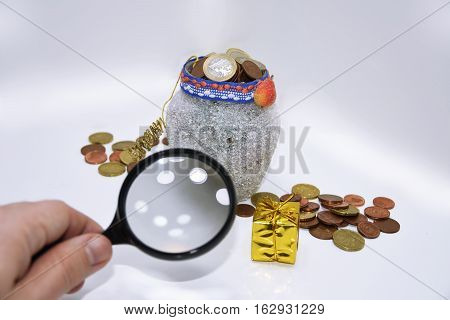Christmas pot with euro coins isolated on white background.